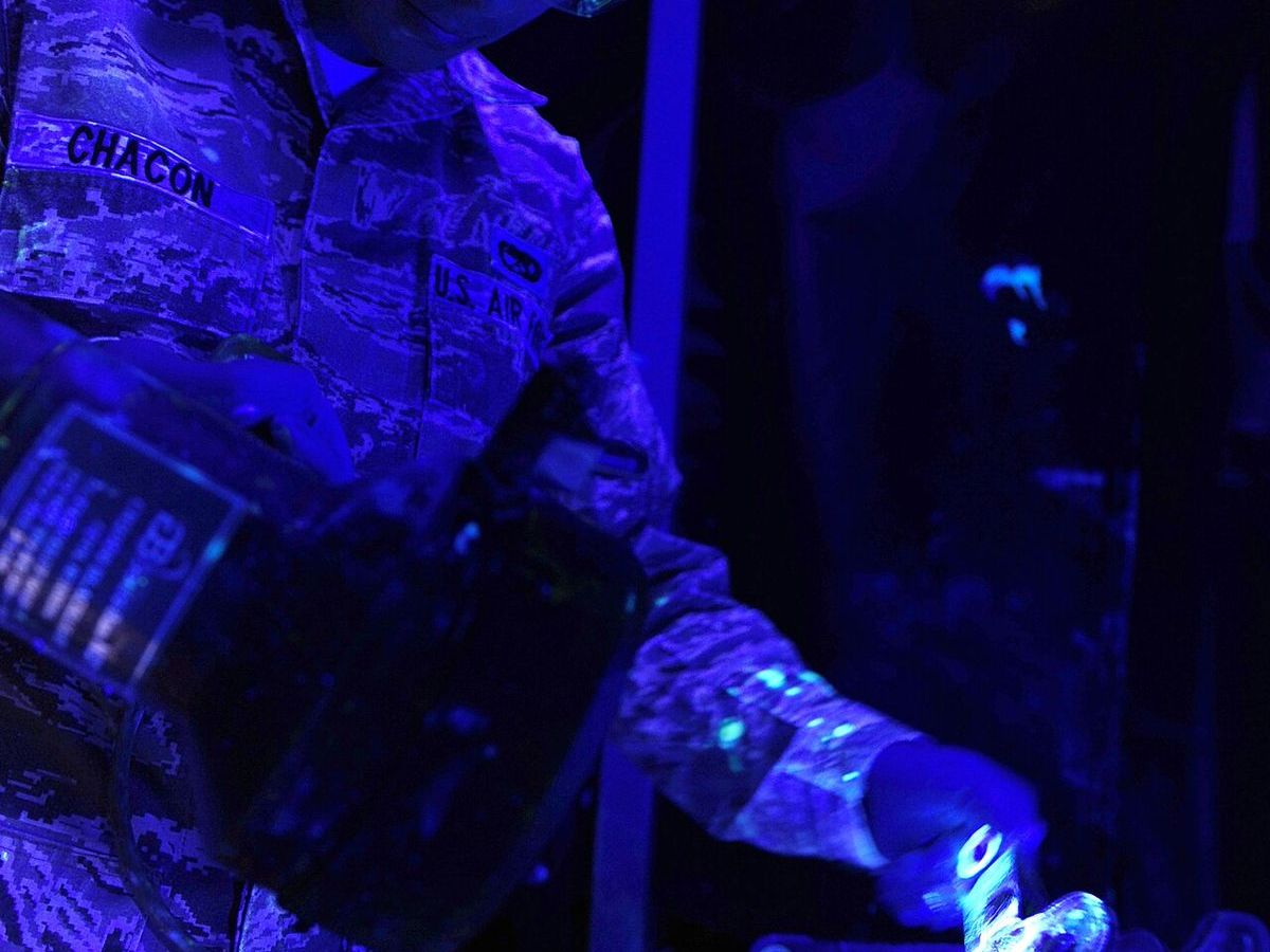 Technician carrying out a liquid dye penetrant inspection on a metal part